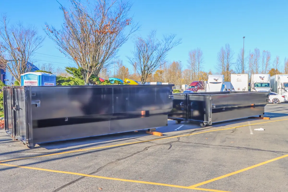 Professional dumpster rental service with roll-off container on residential driveway in Tarpon Springs